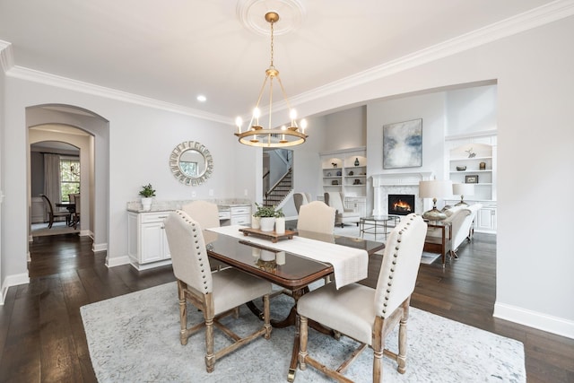 6826 Falls Ridge Ln, College Grove, TN 37046 - dining room with ornamental molding, arched walkways, a fireplace, dark wood-style floors, and a chandelier