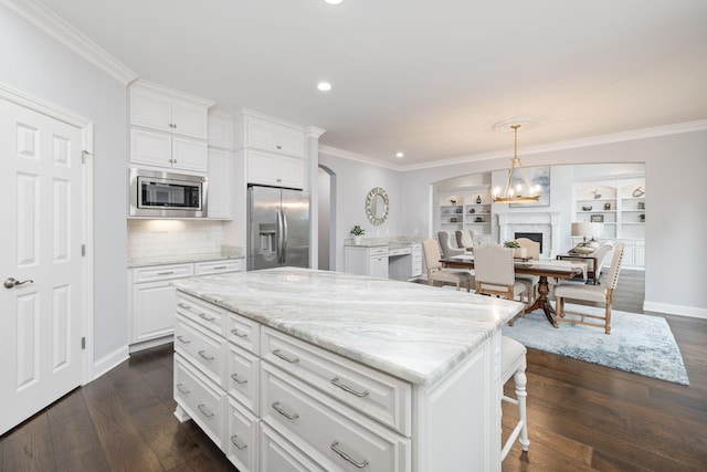 6826 Falls Ridge Ln, College Grove, TN 37046 - kitchen with stainless steel appliances, dark wood-type flooring, recessed lighting, ornamental molding, and a center island