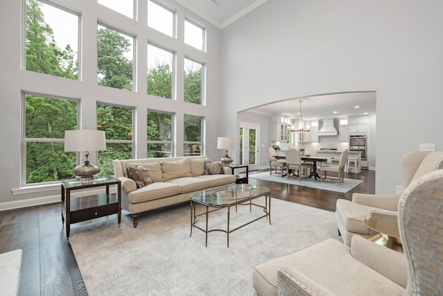 6826 Falls Ridge Ln, College Grove, TN 37046 - living area with crown molding, dark wood-style floors, a high ceiling, arched walkways, and a chandelier