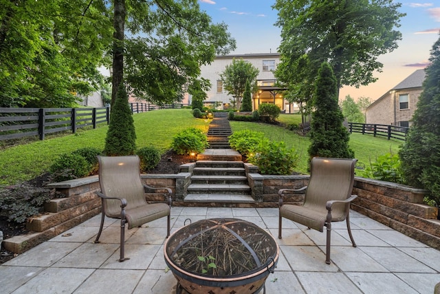 6826 Falls Ridge Ln, College Grove, TN 37046 - patio terrace at dusk with a patio area, stairway, a fire pit, and a fenced backyard