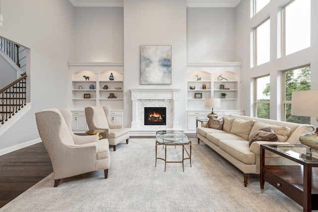 6826 Falls Ridge Ln, College Grove, TN 37046 - living area featuring a high ceiling, stairway, wood finished floors, built in shelves, and a fireplace