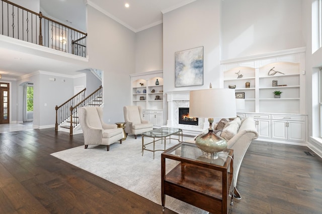 6826 Falls Ridge Ln, College Grove, TN 37046 - living area with a high ceiling, a fireplace, dark wood-type flooring, built in features, and stairs