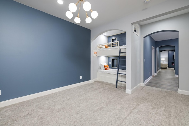 6826 Falls Ridge Ln, College Grove, TN 37046 - unfurnished dining area with arched walkways, carpet flooring, and a chandelier