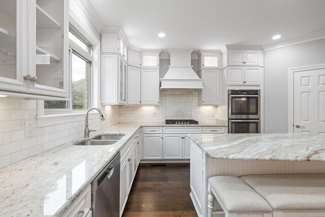 6826 Falls Ridge Ln, College Grove, TN 37046 - kitchen featuring appliances with stainless steel finishes, premium range hood, white cabinetry, light stone countertops, and recessed lighting