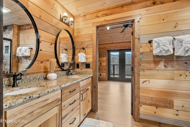 201 Laurel Oaks Way, Gatlinburg, TN 37738 - bathroom with wooden walls, double vanity, french doors, wood finished floors, and wooden ceiling