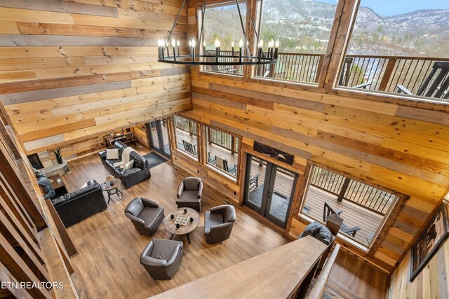 201 Laurel Oaks Way, Gatlinburg, TN 37738 - living room featuring wooden walls, a chandelier, a mountain view, plenty of natural light, and wood finished floors