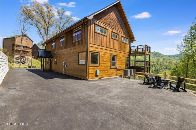 201 Laurel Oaks Way, Gatlinburg, TN 37738 - rear view of house with board and batten siding and a patio