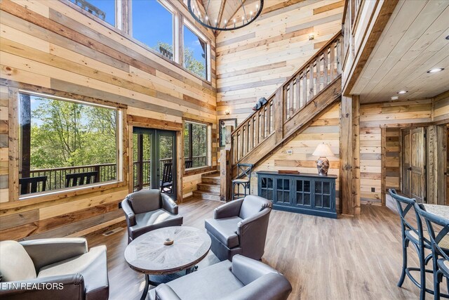 201 Laurel Oaks Way, Gatlinburg, TN 37738 - living room with wooden walls, a high ceiling, stairway, plenty of natural light, and a chandelier