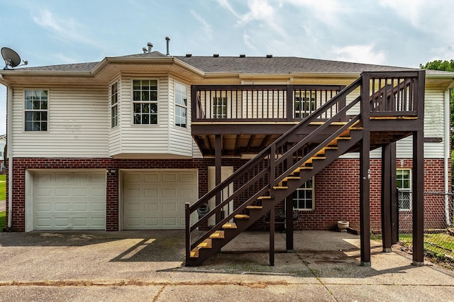 102 Buckhaven Ct, Hendersonville, TN 37075 - back of house with brick siding, an attached garage, asphalt driveway, and a wooden deck