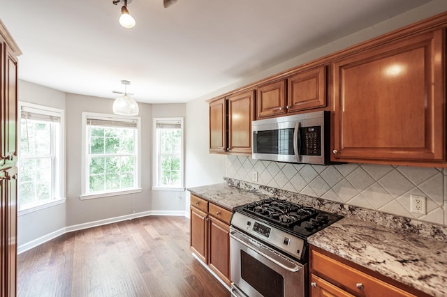 102 Buckhaven Ct, Hendersonville, TN 37075 - kitchen featuring stainless steel appliances, dark wood-style floors, brown cabinets, backsplash, and light stone countertops