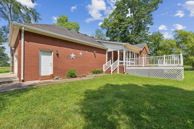 209 Taylor Creek Ln, Chapel Hill, TN 37034 - rear view of house featuring a sunroom, brick siding, a yard, a shingled roof, and a wooden deck