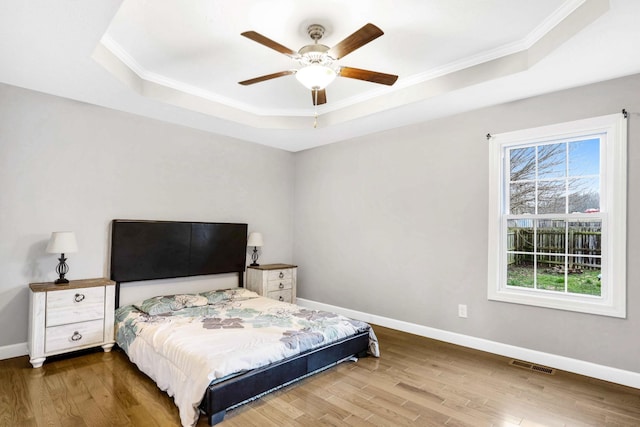 458 Robins Trl, Westmoreland, TN 37186 - bedroom featuring a raised ceiling, crown molding, wood finished floors, and a ceiling fan