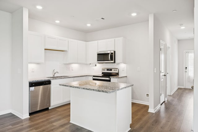 130 Grayson Cir, Chapel Hill, TN 37034 - kitchen with stainless steel appliances, decorative backsplash, light stone countertops, dark wood-style floors, and white cabinetry