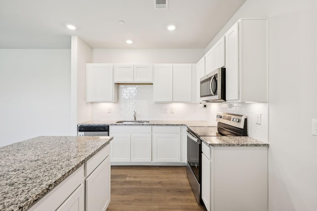 130 Grayson Cir, Chapel Hill, TN 37034 - kitchen featuring appliances with stainless steel finishes, white cabinetry, light stone counters, backsplash, and recessed lighting