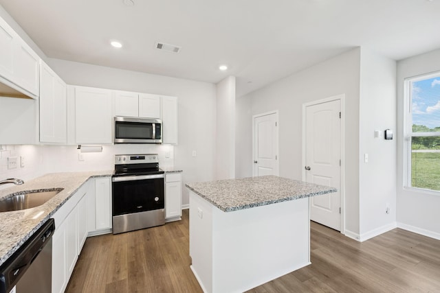 130 Grayson Cir, Chapel Hill, TN 37034 - kitchen featuring stainless steel appliances, wood finished floors, light stone counters, white cabinets, and recessed lighting