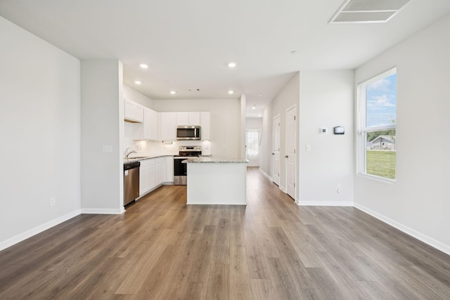 130 Grayson Cir, Chapel Hill, TN 37034 - kitchen featuring stainless steel appliances, wood finished floors, recessed lighting, white cabinets, and a center island