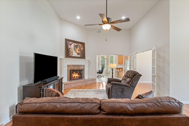 123 River Downs Blvd, Murfreesboro, TN 37128 - living area featuring wood finished floors, a towering ceiling, ceiling fan, a brick fireplace, and recessed lighting