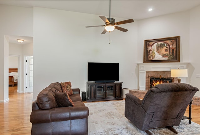 123 River Downs Blvd, Murfreesboro, TN 37128 - living room featuring light wood finished floors, ceiling fan, a brick fireplace, a towering ceiling, and recessed lighting