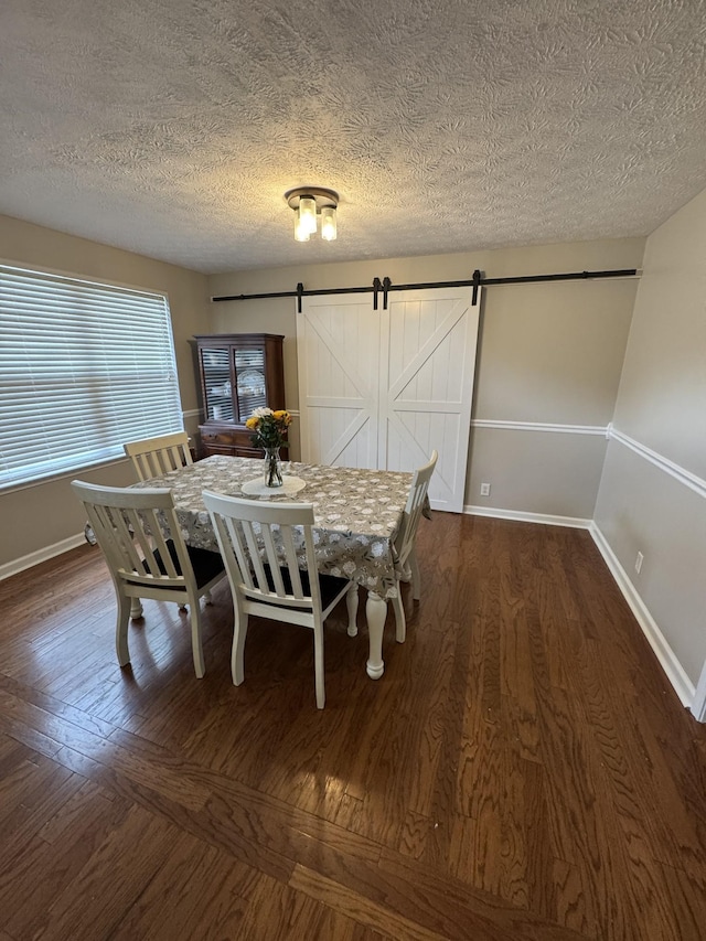 1114 Lea Cir, Lebanon, TN 37087 - dining area featuring a barn door, wood finished floors, and a textured ceiling