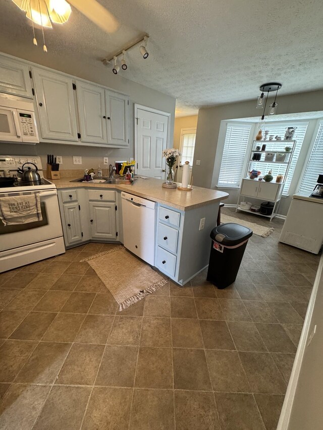 1114 Lea Cir, Lebanon, TN 37087 - kitchen with white appliances, a textured ceiling, a peninsula, white cabinets, and dark tile patterned floors
