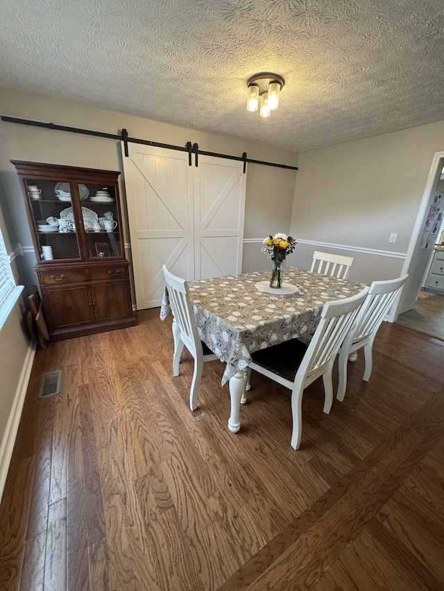 1114 Lea Cir, Lebanon, TN 37087 - dining area with a barn door, light wood-style floors, and a textured ceiling