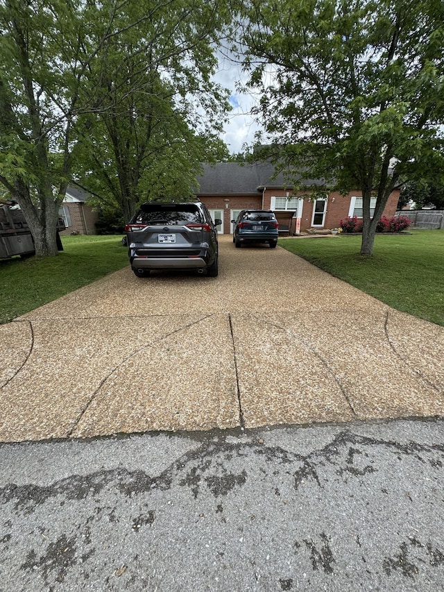 1114 Lea Cir, Lebanon, TN 37087 - view of front of property featuring concrete driveway, a front yard, an attached garage, and brick siding