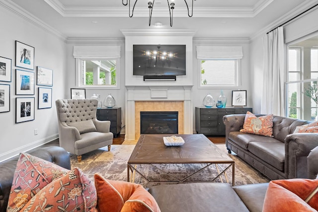 104 Majestic Ln, Franklin, TN 37064 - living room featuring wood finished floors, a tile fireplace, ornamental molding, and a chandelier