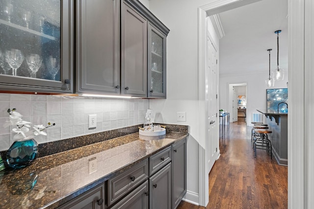 104 Majestic Ln, Franklin, TN 37064 - kitchen with gray cabinets, glass insert cabinets, dark wood-style flooring, backsplash, and crown molding