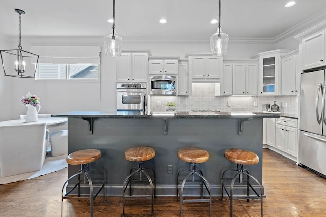 104 Majestic Ln, Franklin, TN 37064 - kitchen featuring stainless steel appliances, white cabinetry, glass insert cabinets, backsplash, and a breakfast bar
