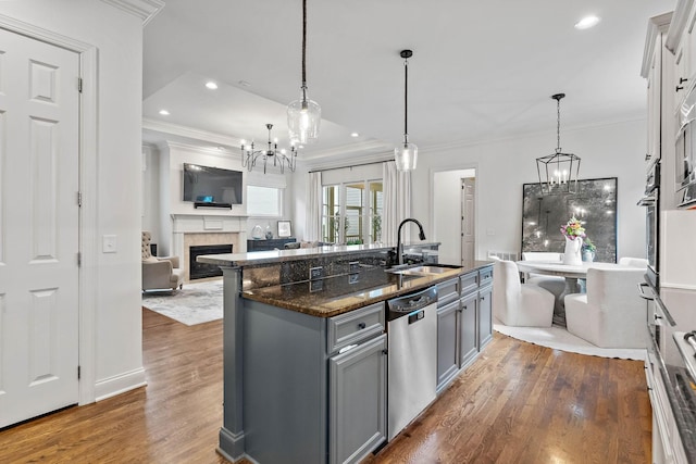104 Majestic Ln, Franklin, TN 37064 - kitchen featuring appliances with stainless steel finishes, a chandelier, gray cabinetry, open floor plan, and crown molding