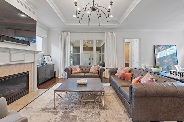 104 Majestic Ln, Franklin, TN 37064 - living area featuring a chandelier, a fireplace, crown molding, and a tray ceiling
