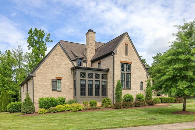 4310 Kings Camp Ct, Arrington, TN 37014 - rear view of property featuring brick siding, a chimney, a yard, and a shingled roof