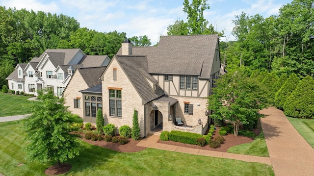 4310 Kings Camp Ct, Arrington, TN 37014 - view of front of home featuring stone siding, roof with shingles, a front yard, and a chimney