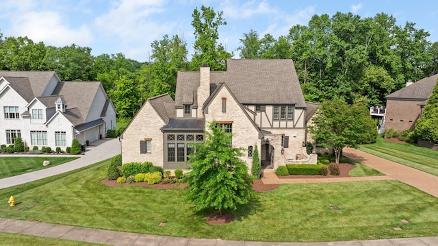 4310 Kings Camp Ct, Arrington, TN 37014 - view of front of house featuring stone siding, a chimney, a front yard, and a garage