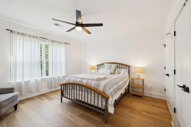 973 Hall Cemetery Rd, Burns, TN 37029 - bedroom with light wood-style flooring, a closet, and ceiling fan