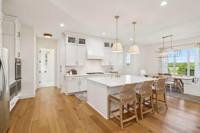 973 Hall Cemetery Rd, Burns, TN 37029 - kitchen with light wood-style floors, recessed lighting, light countertops, white cabinets, and gas stovetop