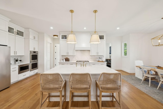 973 Hall Cemetery Rd, Burns, TN 37029 - kitchen featuring stainless steel appliances, light wood finished floors, glass insert cabinets, white cabinets, and recessed lighting
