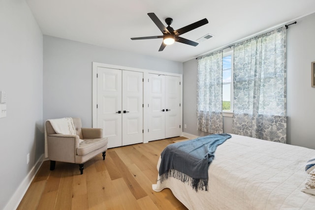 973 Hall Cemetery Rd, Burns, TN 37029 - bedroom with multiple closets, wood finished floors, and a ceiling fan