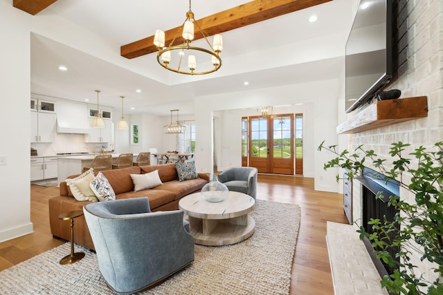 973 Hall Cemetery Rd, Burns, TN 37029 - living area featuring a chandelier, a fireplace, beamed ceiling, light wood finished floors, and recessed lighting