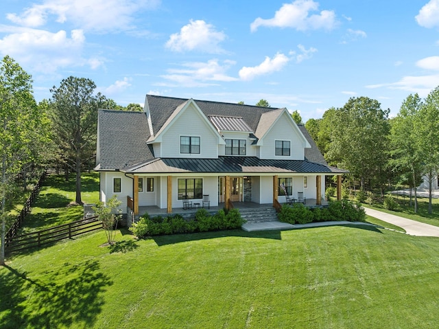 973 Hall Cemetery Rd, Burns, TN 37029 - modern farmhouse style home featuring a standing seam roof, a porch, and a metal roof