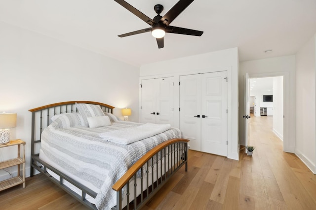 973 Hall Cemetery Rd, Burns, TN 37029 - bedroom featuring two closets, light wood-style flooring, and ceiling fan