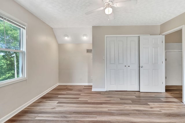 141 Springbrook Pl, Joelton, TN 37080 - unfurnished bedroom featuring light wood finished floors, a closet, a textured ceiling, a ceiling fan, and vaulted ceiling