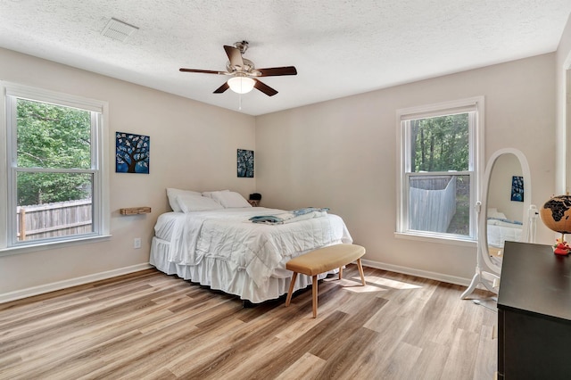 141 Springbrook Pl, Joelton, TN 37080 - bedroom with light wood-type flooring, multiple windows, a textured ceiling, and ceiling fan