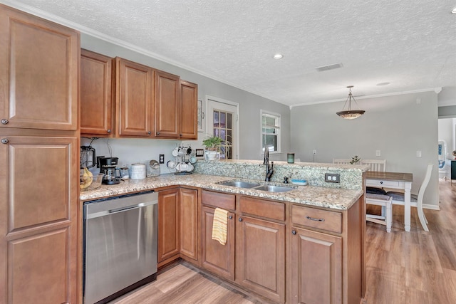 141 Springbrook Pl, Joelton, TN 37080 - kitchen with stainless steel dishwasher, a peninsula, light wood-style flooring, light stone counters, and brown cabinetry