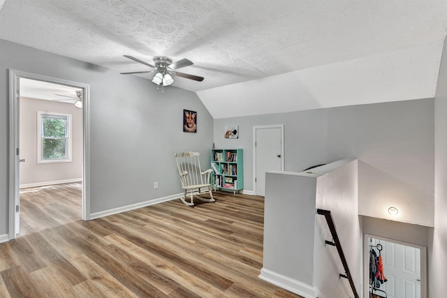 141 Springbrook Pl, Joelton, TN 37080 - sitting room featuring an upstairs landing, a ceiling fan, wood finished floors, a textured ceiling, and vaulted ceiling