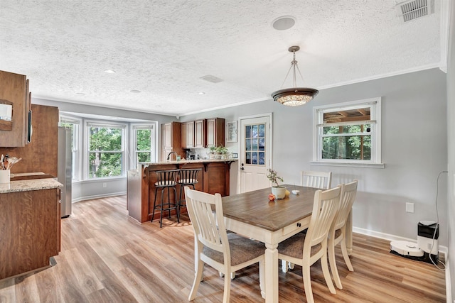 141 Springbrook Pl, Joelton, TN 37080 - dining space with a textured ceiling, light wood-style floors, crown molding, and recessed lighting