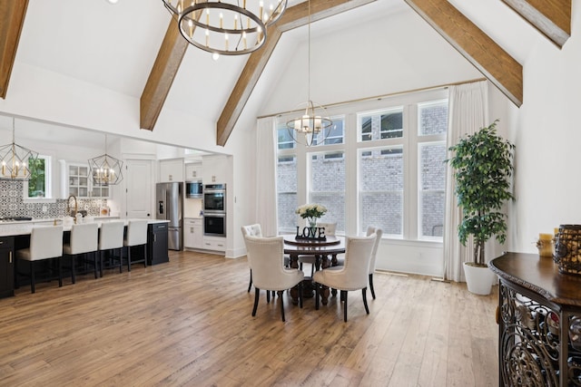5128 Terravista Ln, Franklin, TN 37064 - dining room with a chandelier, beam ceiling, light wood-style floors, and high vaulted ceiling