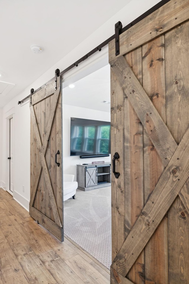 5128 Terravista Ln, Franklin, TN 37064 - hall featuring a barn door and wood finished floors
