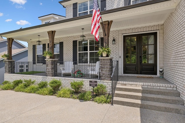 5128 Terravista Ln, Franklin, TN 37064 - view of exterior entry featuring french doors, covered porch, and brick siding