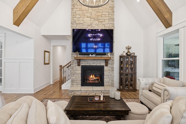 5128 Terravista Ln, Franklin, TN 37064 - living area featuring high vaulted ceiling, a stone fireplace, beam ceiling, wood finished floors, and stairs
